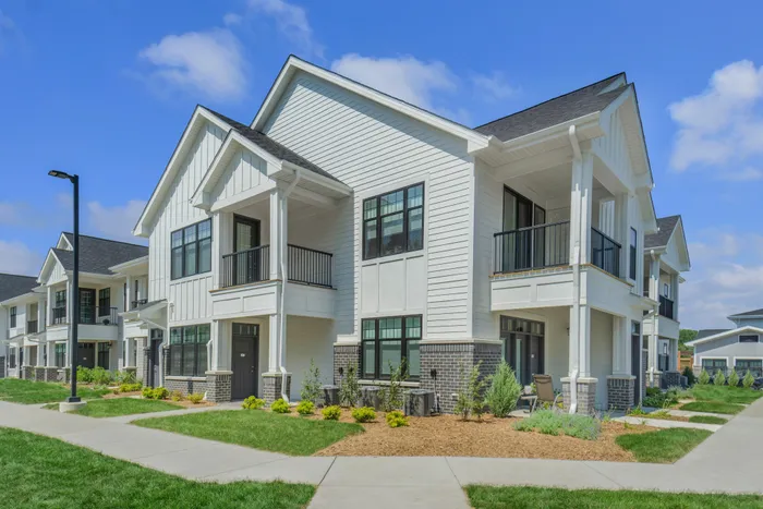 Resident building exterior at Seasons at Franklin Apartments in Franklin, Wisconsin featuring private entries and attached garage access.