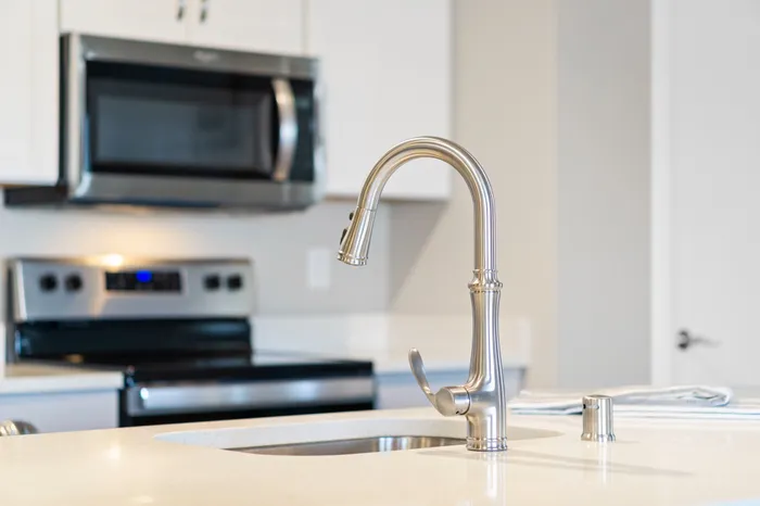 Kitchen at High Bluff at Creekwood Crossing in Menomonee Falls, Wisconsin, featuring modern finishes within apartment homes.