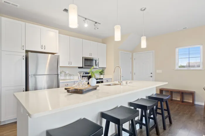Kitchen at High Bluff at Creekwood Crossing in Menomonee Falls, Wisconsin, featuring modern finishes within apartment homes.
