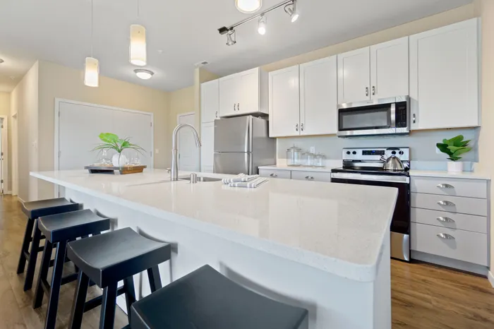 Kitchen at High Bluff at Creekwood Crossing in Menomonee Falls, Wisconsin, featuring modern finishes within apartment homes.