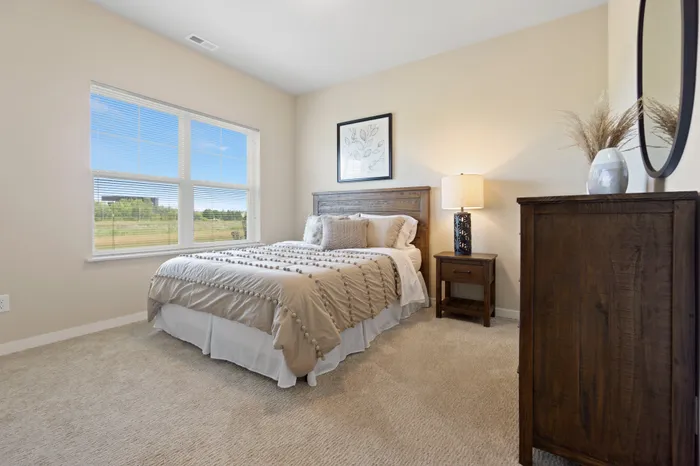 Bedroom at High Bluff at Creekwood Crossing in Menomonee Falls, Wisconsin, offering comfortable private living space.