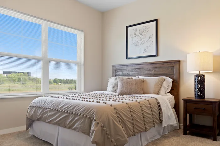 Bedroom at High Bluff at Creekwood Crossing in Menomonee Falls, Wisconsin, offering comfortable private living space.