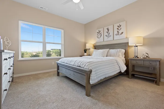 Bedroom at High Bluff at Creekwood Crossing in Menomonee Falls, Wisconsin, offering comfortable private living space.