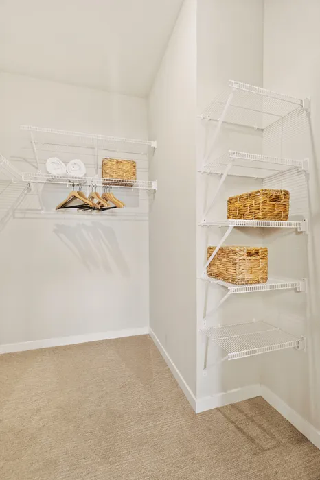 Walk-in closet at Seasons at Franklin Apartments in Franklin, Wisconsin offering additional storage and organization space.