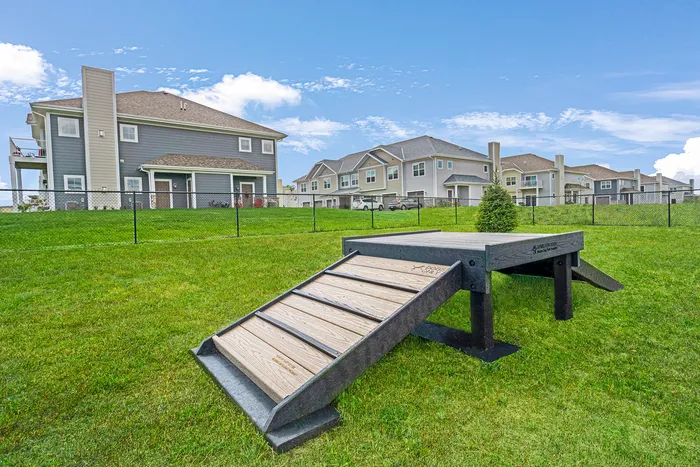 Fenced-in dog park at High Bluff at Creekwood Crossing in Menomonee Falls, Wisconsin, providing space for pets.