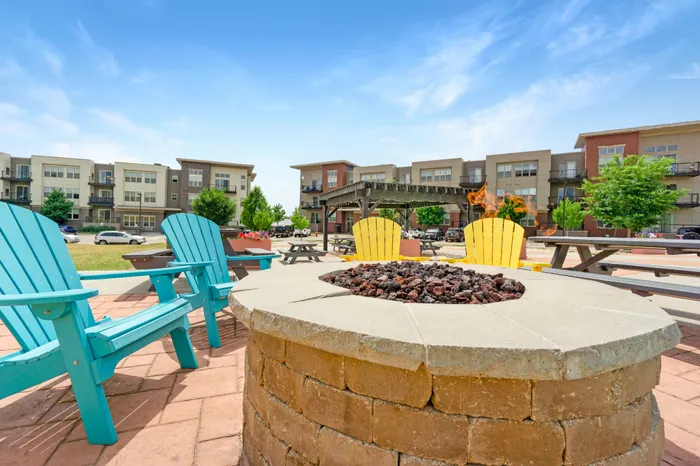 Outdoor courtyard with grilling, picnic areas, and fire pit at 50Twenty Apartments in Madison, Wisconsin.