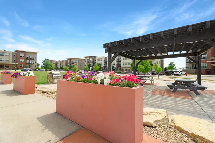 Outdoor courtyard with grilling, picnic areas, and fire pit at 50Twenty Apartments in Madison, Wisconsin.