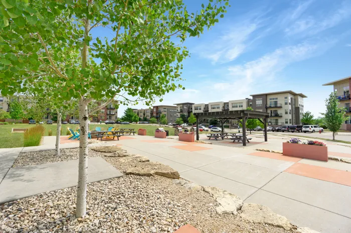 Outdoor courtyard with grilling, picnic areas, and fire pit at 50Twenty Apartments in Madison, Wisconsin.