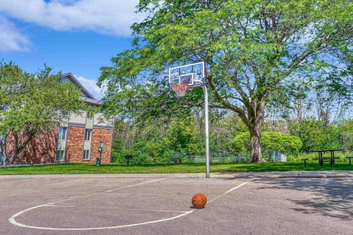 Outdoor basketball court at Creekwood Apartments in Green Bay, Wisconsin for recreational use.