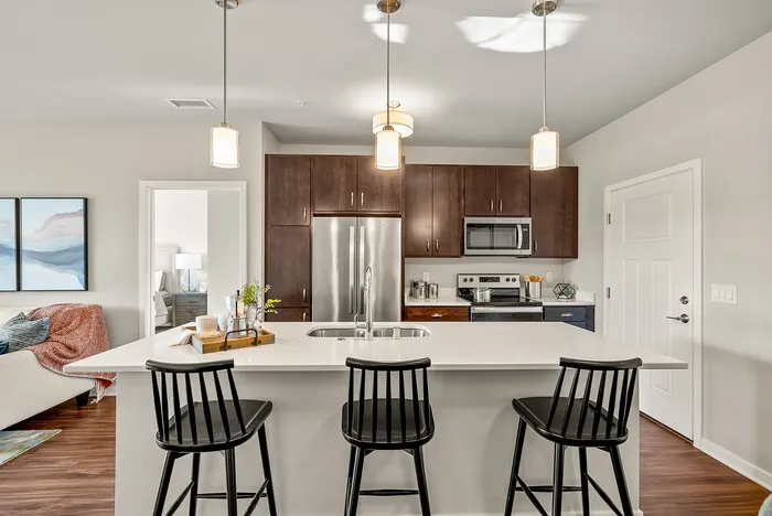 Apartment kitchen at Seasons at Orchard Hills in Oak Creek, Wisconsin, featuring updated finishes and functional storage.