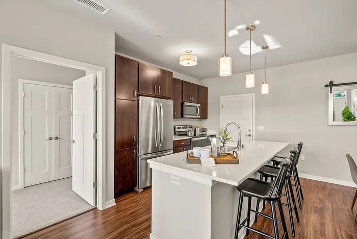 Apartment kitchen at Seasons at Orchard Hills in Oak Creek, Wisconsin, featuring updated finishes and functional storage.