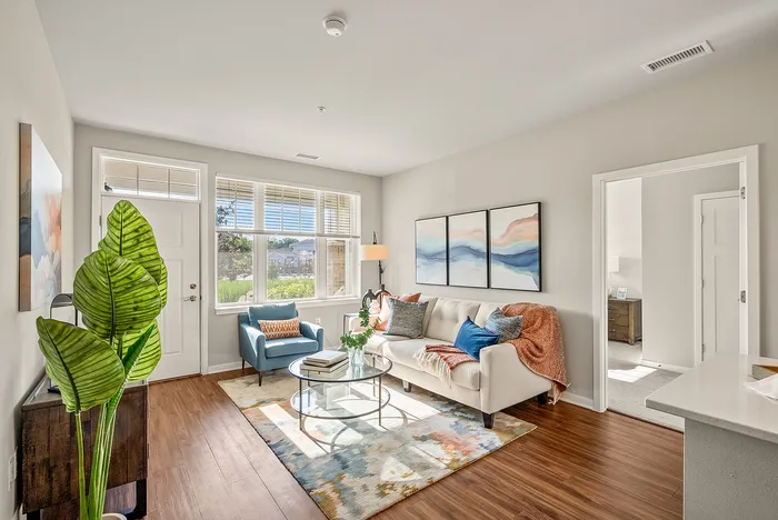 Living room at Seasons at Orchard Hills in Oak Creek, Wisconsin, offering an open layout with natural light.