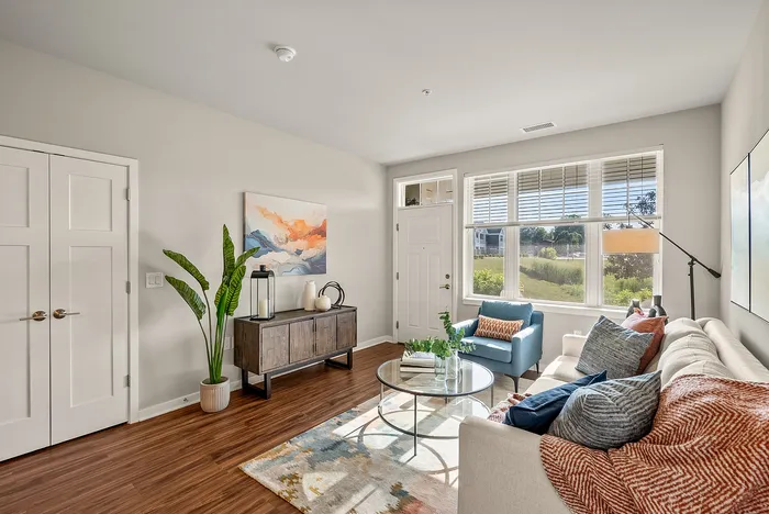 Living room at Seasons at Orchard Hills in Oak Creek, Wisconsin, offering an open layout with natural light.