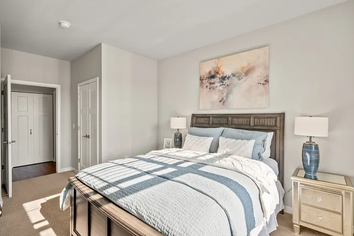 Primary bedroom at Seasons at Orchard Hills in Oak Creek, Wisconsin, with ample space and natural light.