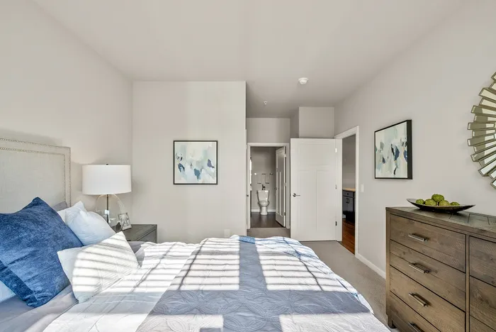 Primary bedroom at Seasons at Orchard Hills in Oak Creek, Wisconsin, with ample space and natural light.