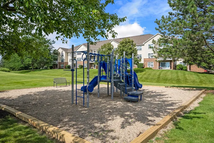 Community playground at Riverwood Apartments in Kenosha, Wisconsin designed for outdoor recreation.