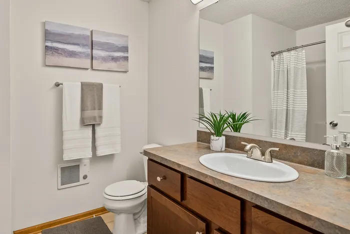 Primary bathroom at Riverwood Apartments in Kenosha, Wisconsin with modern fixtures and finishes.