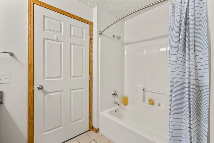 Primary bathroom at Riverwood Apartments in Kenosha, Wisconsin with modern fixtures and finishes.