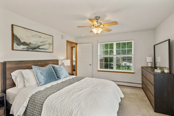 Primary bedroom at Riverwood Apartments in Kenosha, Wisconsin offering a comfortable living space.