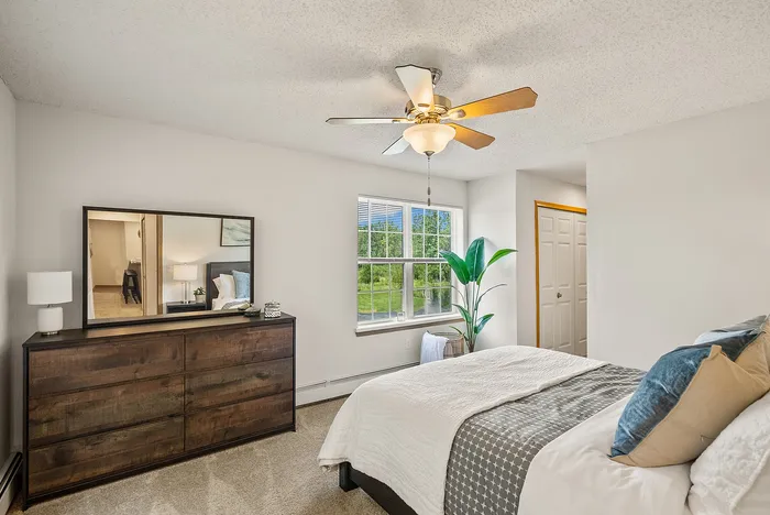 Primary bedroom at Riverwood Apartments in Kenosha, Wisconsin offering a comfortable living space.