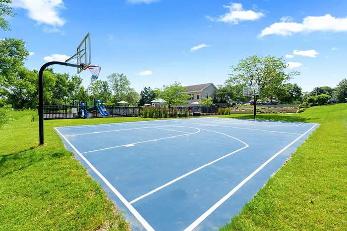 Full-size outdoor basketball court at Saddlebrook Apartments in Pewaukee, Wisconsin.
