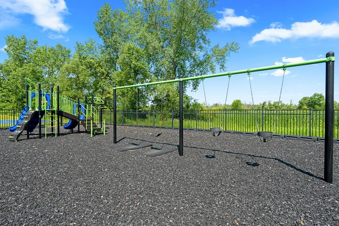 Community playground at Saddlebrook Apartments in Pewaukee, Wisconsin for outdoor recreation.