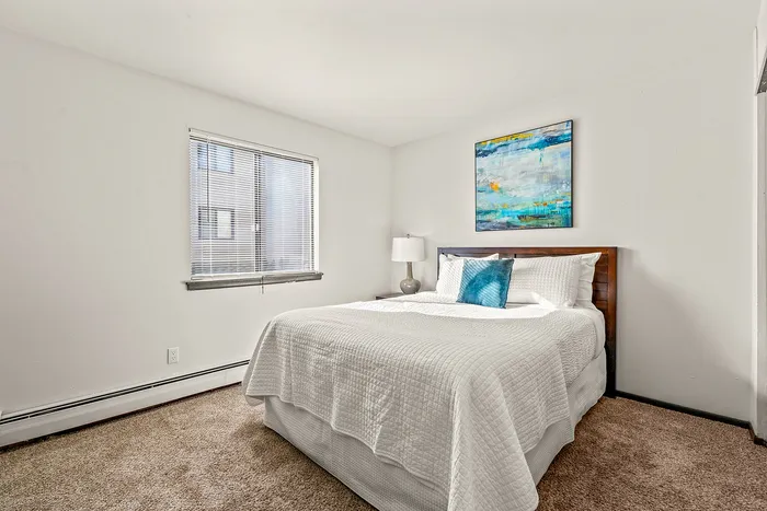 Bedroom at Fitchburg Square Apartments in Fitchburg, Wisconsin, offering comfortable sleeping space within 1 bedroom and 2 bedroom apartment layouts.
