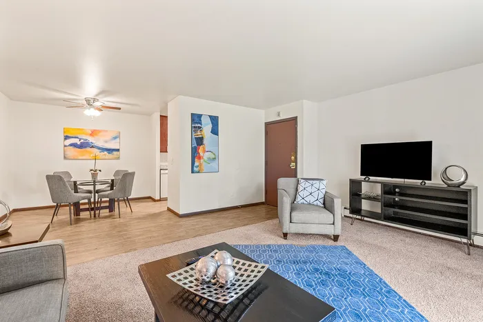 Living room at Fitchburg Square Apartments in Fitchburg, Wisconsin, showcasing open living space in 1 bedroom and 2 bedroom apartment homes.