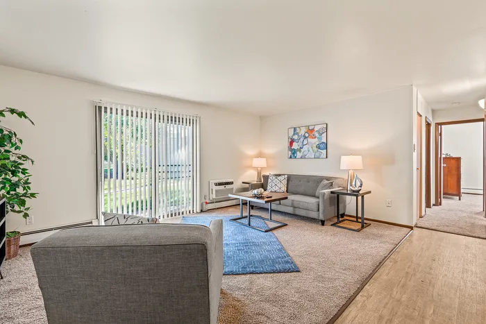 Living room at Fitchburg Square Apartments in Fitchburg, Wisconsin, showcasing open living space in 1 bedroom and 2 bedroom apartment homes.