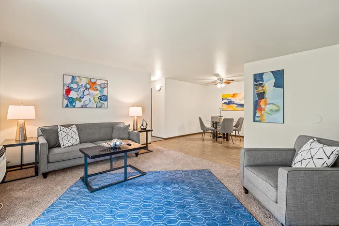 Living room at Fitchburg Square Apartments in Fitchburg, Wisconsin, showcasing open living space in 1 bedroom and 2 bedroom apartment homes.