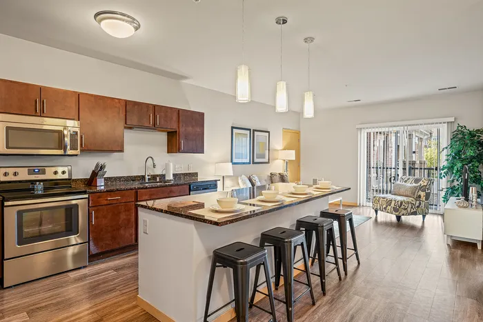 Apartment kitchen at Elan Apartments in Fitchburg, Wisconsin featuring modern finishes and appliances.
