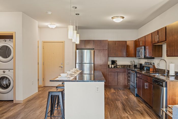 Apartment kitchen at Elan Apartments in Fitchburg, Wisconsin featuring modern finishes and appliances.