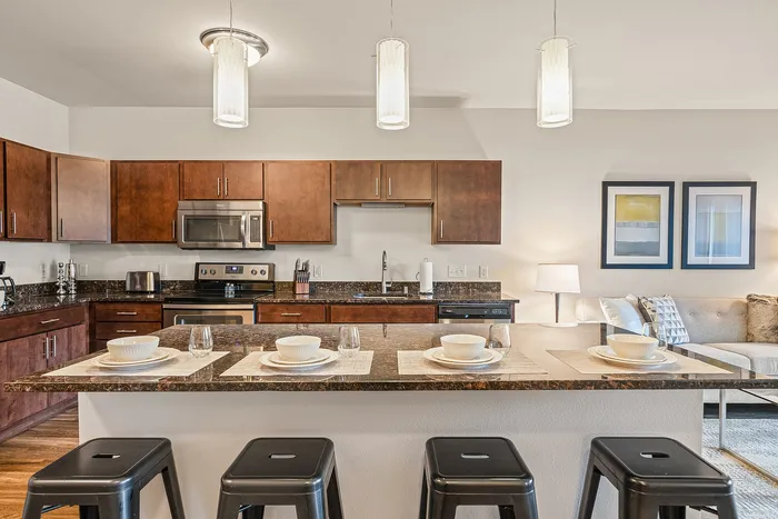 Apartment kitchen at Elan Apartments in Fitchburg, Wisconsin featuring modern finishes and appliances.