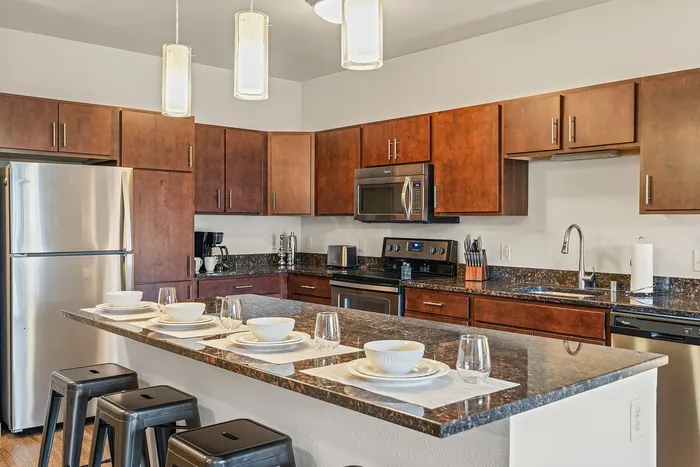 Apartment kitchen at Elan Apartments in Fitchburg, Wisconsin featuring modern finishes and appliances.
