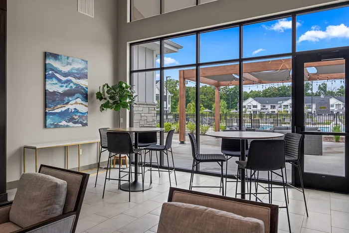 Clubhouse interior at Seasons at Franklin Apartments in Franklin, Wisconsin offering shared spaces for relaxing, working, and socializing.