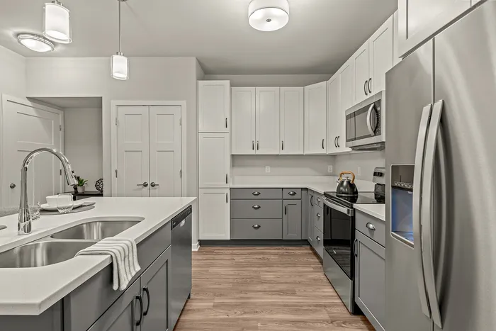 Kitchen at Seasons at Franklin Apartments in Franklin, Wisconsin featuring ample cabinet storage, updated appliances, and functional layout.
