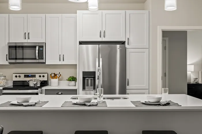 Kitchen at Seasons at Franklin Apartments in Franklin, Wisconsin featuring ample cabinet storage, updated appliances, and functional layout.