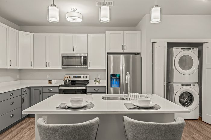 Kitchen at Seasons at Franklin Apartments in Franklin, Wisconsin featuring ample cabinet storage, updated appliances, and functional layout.