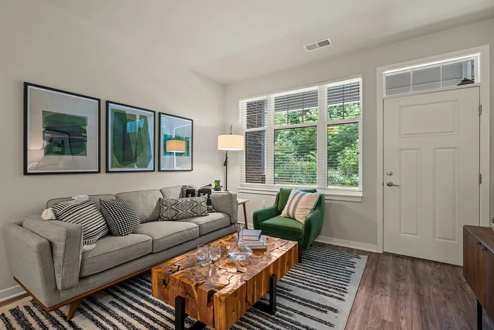 Living room at Seasons at Franklin Apartments in Franklin, Wisconsin offering open layouts and natural light.