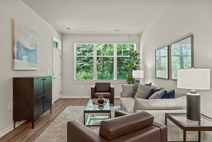 Living room at Seasons at Franklin Apartments in Franklin, Wisconsin offering open layouts and natural light.