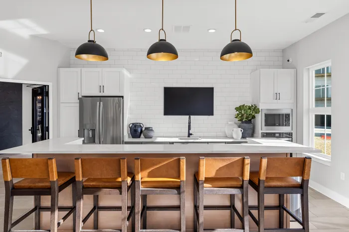 Modern clubhouse interior with lounge and kitchen space at Apex at Verona in Verona, WI