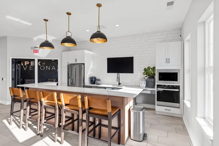 Modern clubhouse interior with lounge and kitchen space at Apex at Verona in Verona, WI
