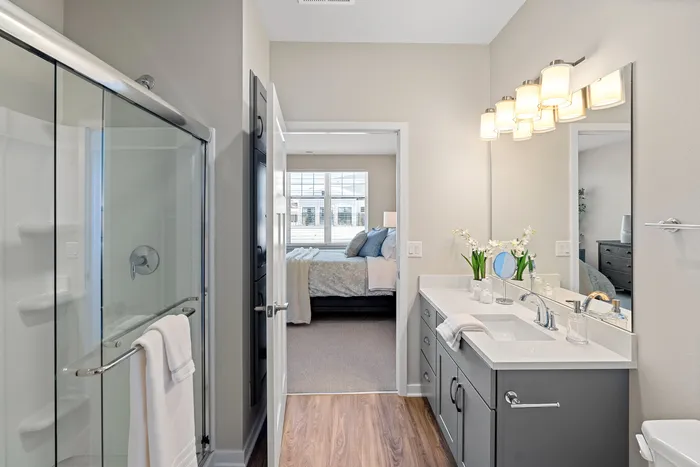 Primary bathroom at Seasons at Grafton Apartments in Grafton, Wisconsin with clean finishes, ample vanity space, and storage.