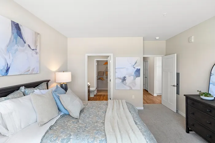 Primary bedroom at Seasons at Grafton Apartments in Grafton, Wisconsin offering generous space and flexible furniture layouts.