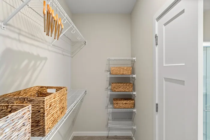 Walk-in closet at Seasons at Grafton Apartments in Grafton, Wisconsin offering additional storage and organization space.