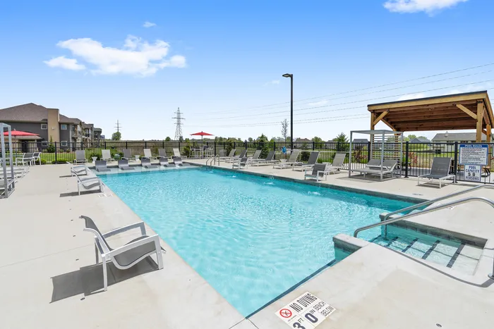 Resort-style swimming pool at High Bluff Townhomes in Grafton, Wisconsin offering outdoor relaxation for residents.