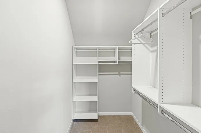 Walk-in closet at High Bluff Townhomes in Grafton, Wisconsin offering organized storage space.