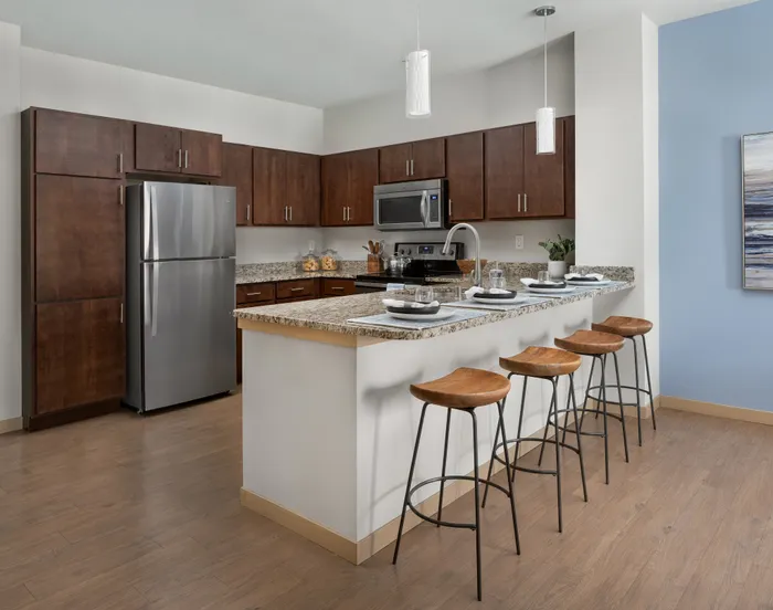 Apartment kitchen featuring updated cabinetry, modern appliances, and functional layouts.