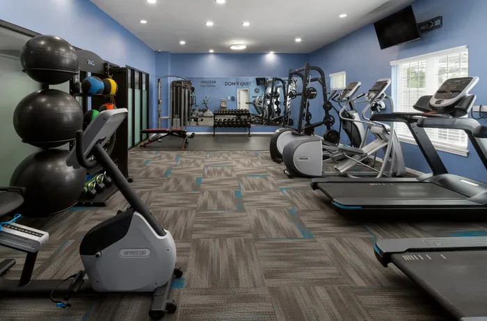 Fitness center at Manchester Oaks Apartments in Franklin, Wisconsin featuring updated exercise equipment for residents.