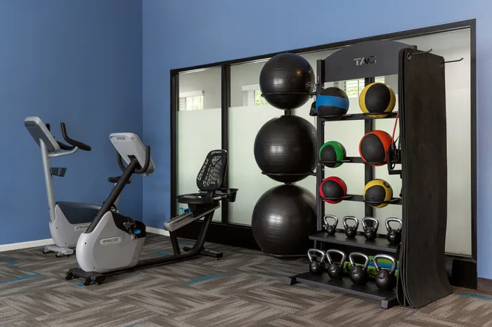 Fitness center at Manchester Oaks Apartments in Franklin, Wisconsin featuring updated exercise equipment for residents.